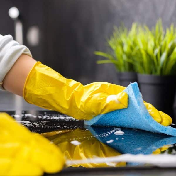 House Cleaner Wiping Surfaces When Cleaning a kitchen
